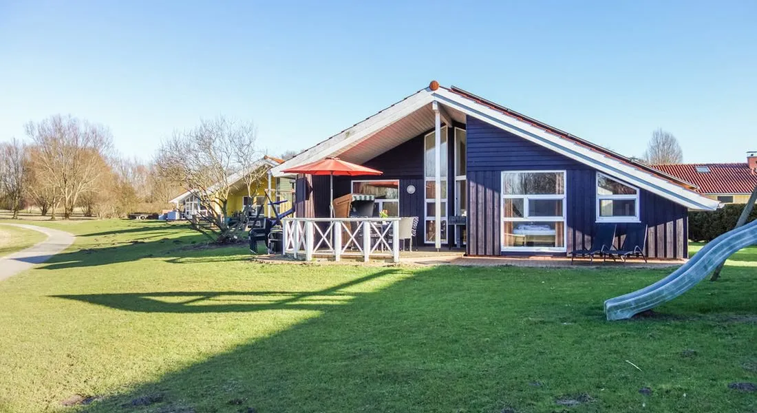 Blaues Ferienhaus Neu-Seeland 69 mit Terrasse und Rutsche im Garten